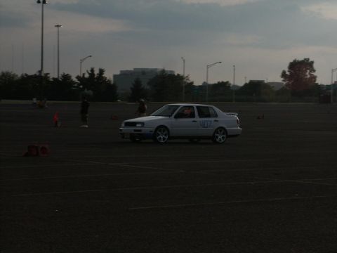 2001 Mercury Grand Marquis - A white sedan with racing numbers participates in an event on a paved lot.