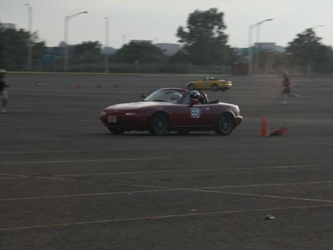 2001 Mercury Grand Marquis - Two convertibles race on a track with orange cones marking the course.