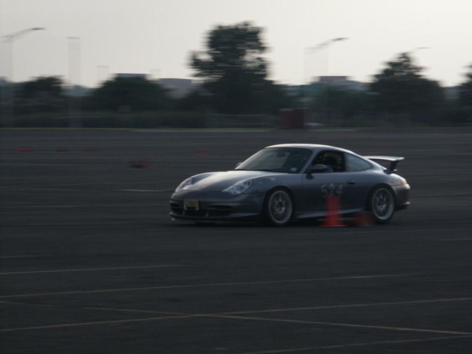 Silver Porsche 911 on track with number 324 on door