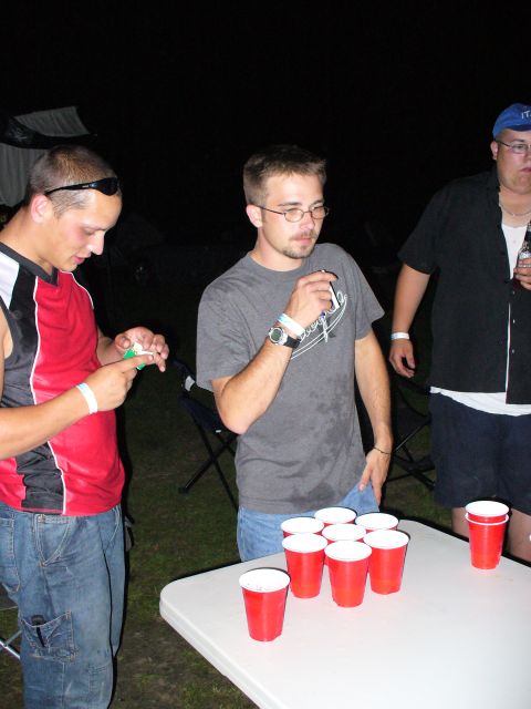 1991 Ford Probe - A group of friends enjoys a game of beer pong outdoors at night.