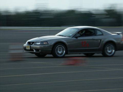 2001 Mercury Grand Marquis - A gray coupe with a red number 12 on its door is seen in motion on a track.