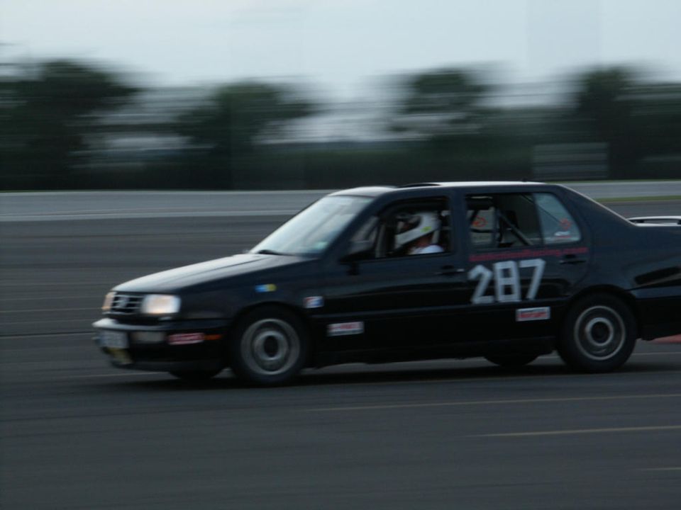 Side view of black sedan with racing number 287 on door