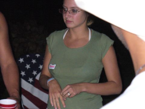 1991 Ford Probe - A woman stands in front of an American flag, partially obscured by a white object.