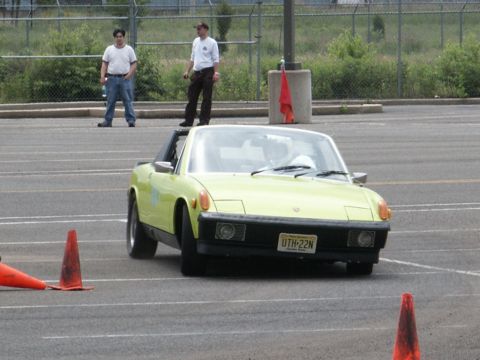 2001 Mercury Grand Marquis - A yellow Porsche 914 navigates a course marked by traffic cones.