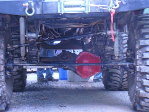 1996 Ford Bronco - Close-up of the undercarriage of a heavily modified off-road vehicle, focusing on the drivetrain components.