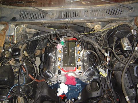 1986 Ford Bronco - Engine bay view showing a V8 engine with extensive wiring and plumbing.
