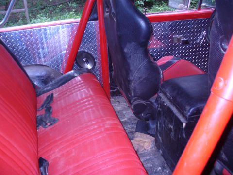 1996 Ford Bronco - Interior view of a vehicle with custom roll cage and diamond plate panels.