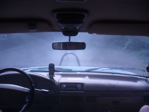 1996 Ford Bronco - Interior view of a 1996 Ford Bronco, looking out through the windshield on a misty day.