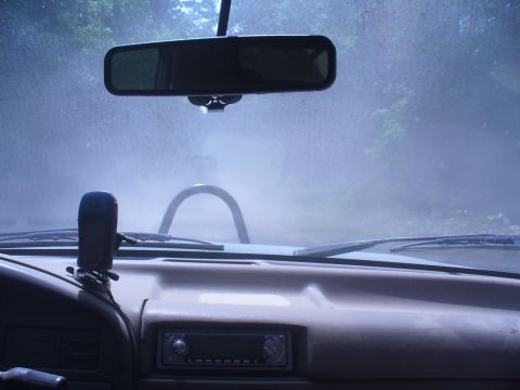 1996 Ford Bronco - Driving through dusty conditions with a roll bar visible inside the vehicle.