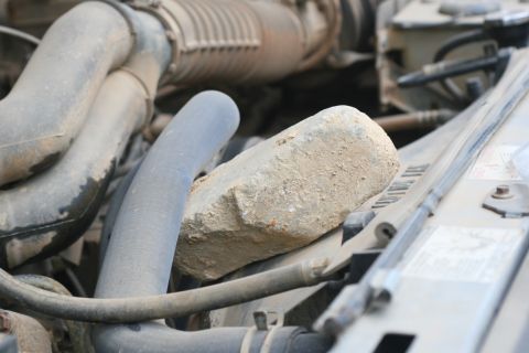 1990 Ford Bronco - Somehow Johnski's upper radiator hose started hitting the fan blade, which quickly wore a hole in the hose. I assume the rock is a temporar…