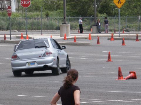 2001 Mercury Grand Marquis - A Mitsubishi Lancer Evolution VIII is driven through a cone course, likely for a performance driving event.