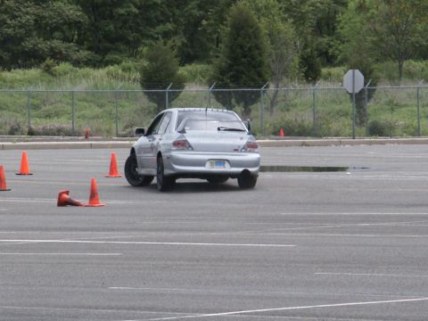 2001 Mercury Grand Marquis - Silver sedan navigates an autocross course marked by orange cones.