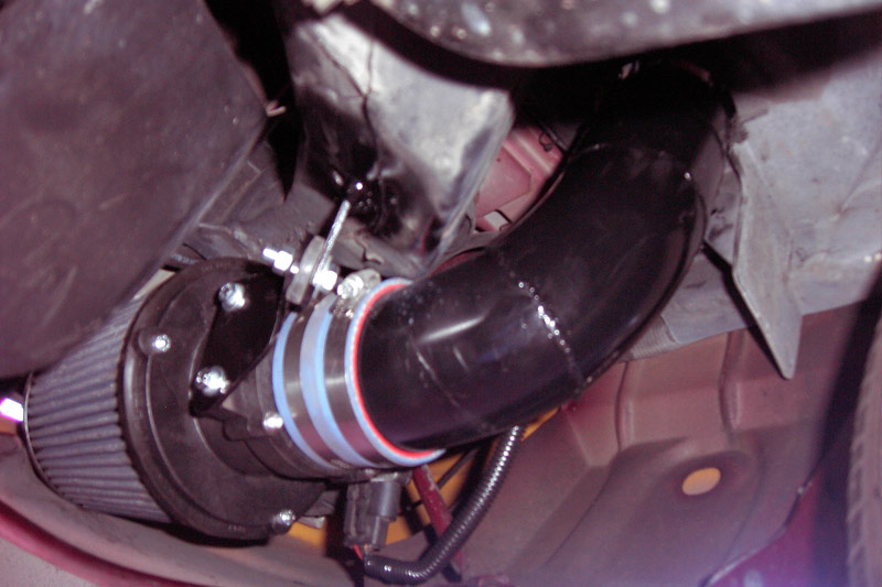 Custom cold-air intake tube with silicone coupler and cone filter in an engine bay