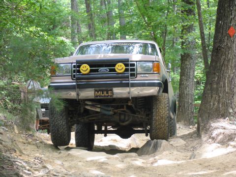 1995 Ford C-350 (Centurion Conversions) - Off-roading in a lifted Ford F-Series truck on a challenging rocky trail.