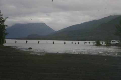 2003 Jeep TJ - Fishing scene with people in the water and mountains in the distance, a truck is parked nearby.