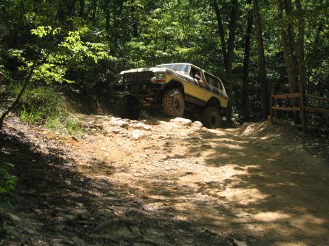 1979 Ford Bronco - Off-roading in a classic Ford Bronco on a challenging dirt and rock path.