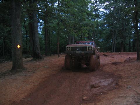1979 Ford Bronco - This 1979 Ford Bronco navigates a challenging muddy trail through a wooded area.