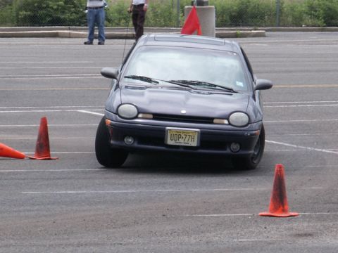 2001 Mercury Grand Marquis - Dodge Neon driving through a cone course, likely for autocross or driver training.