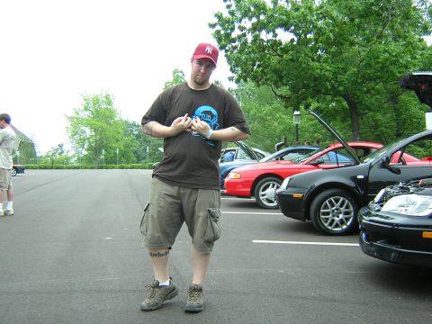 1995 Ford Probe - A man poses for a photo in a parking lot with several cars parked behind him.