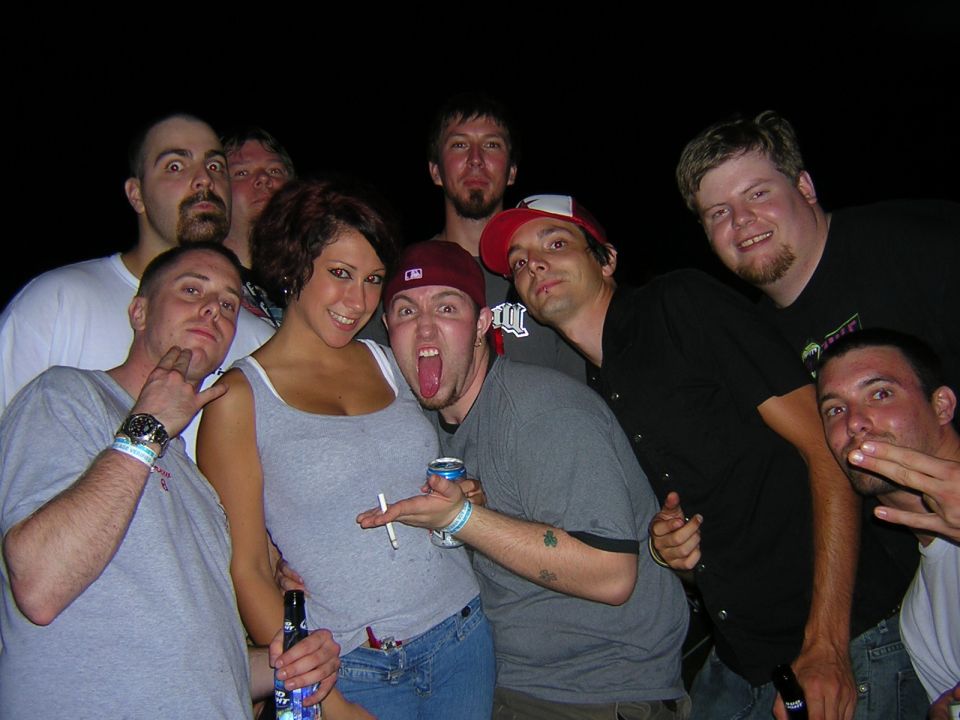Group of eight people posing for a photo, some making faces