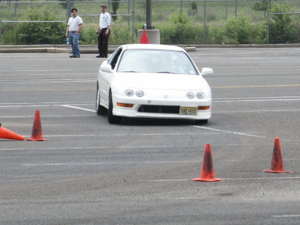 White Acura Integra coupe navigating a cone course