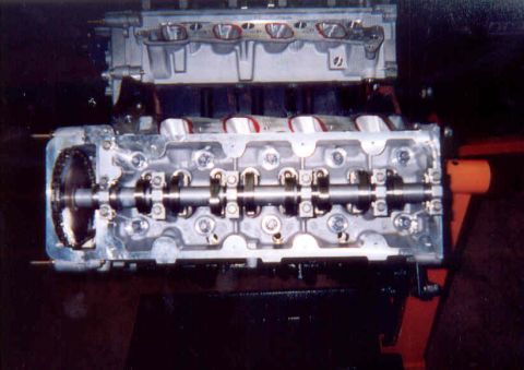 1992 Ford Crown Victoria - Overhead shot of a V8 short block on an engine stand mid-assembly, with both aluminum overhead-cam cylinder heads installed and valve cover…