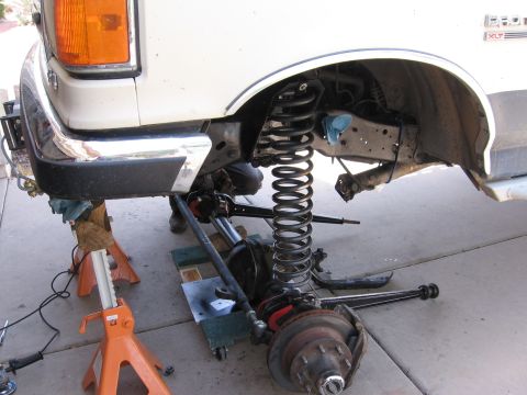 1990 Ford Bronco - Front suspension components of a 1990 Ford F-250 are visible during a repair process.