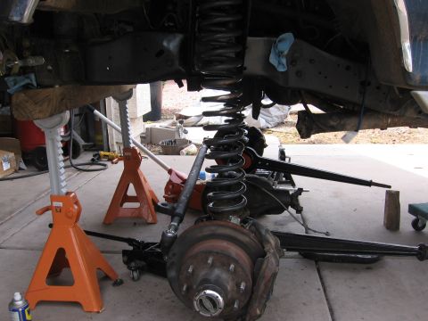 1990 Ford Bronco - Underbody view of vehicle suspension and frame parts being worked on.