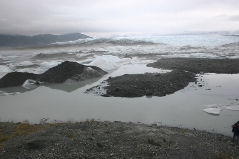 2003 Jeep TJ - A vast glacial landscape with icebergs scattered across a calm lake under an overcast sky.