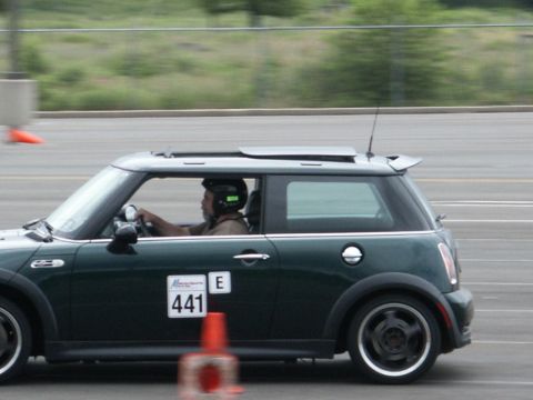 2001 Mercury Grand Marquis - A dark green Mini Cooper with racing numbers is seen on the track during a timed event.