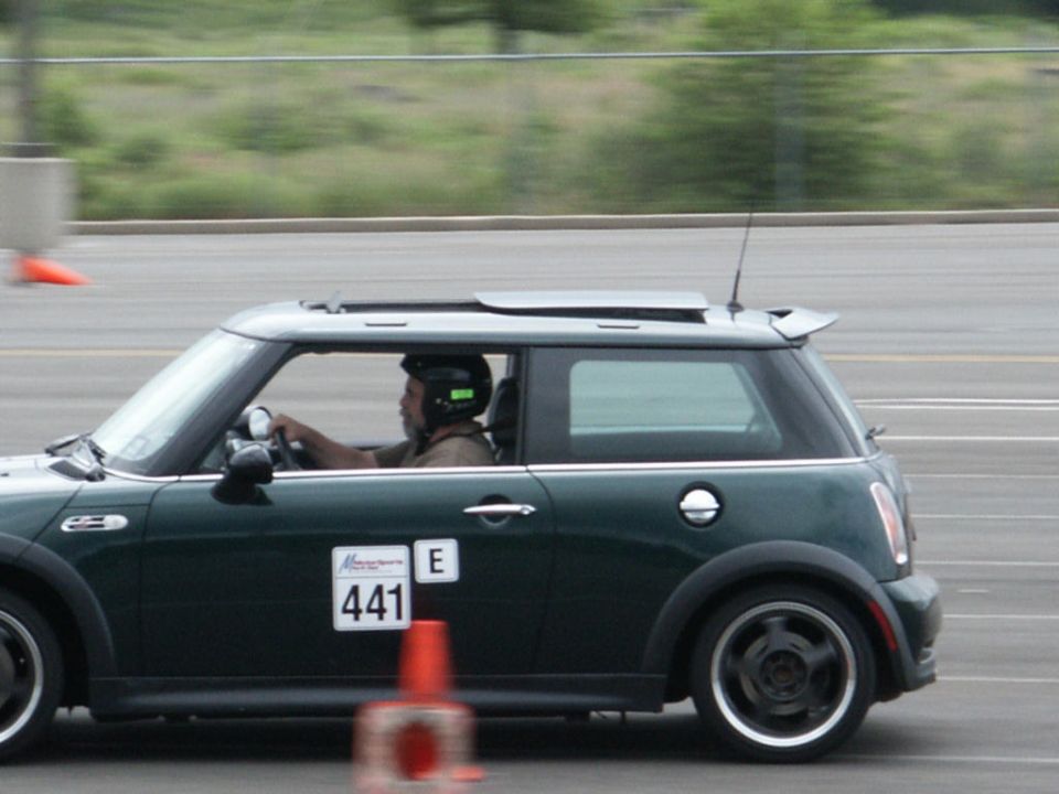 Side view of dark green Mini Cooper with racing numbers 441 and E
