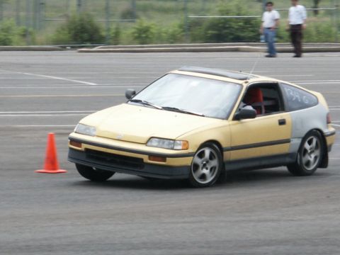 2001 Mercury Grand Marquis - A yellow and grey Honda CRX navigates a course marked by orange cones.