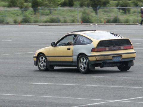 2001 Mercury Grand Marquis - This Honda CRX has a two-tone paint job with yellow and silver panels, and race numbers on the window.
