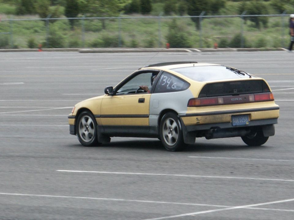 Yellow and silver Honda CRX driving on asphalt, number 1346 on window, license plate AUH1258