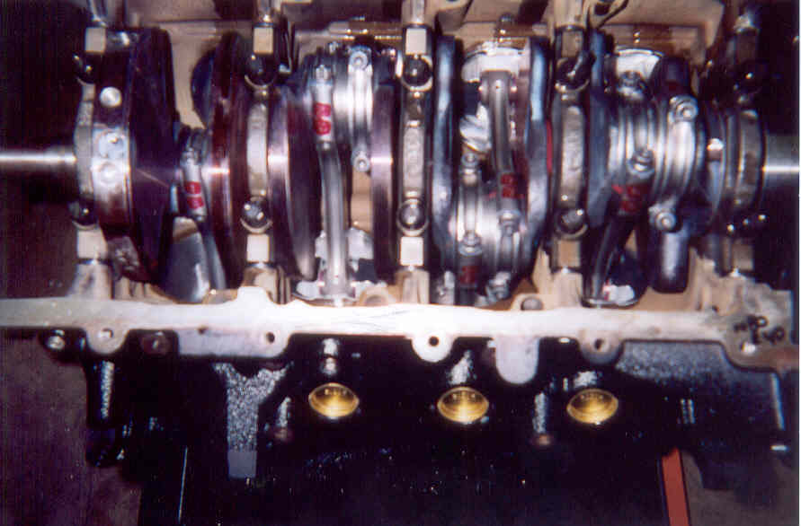 V8 crankshaft and connecting rods installed in a block during engine assembly