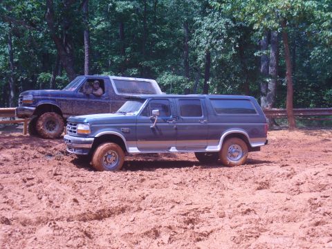 1996 Ford Bronco - Two SUVs are stuck in the mud during an off-road excursion.