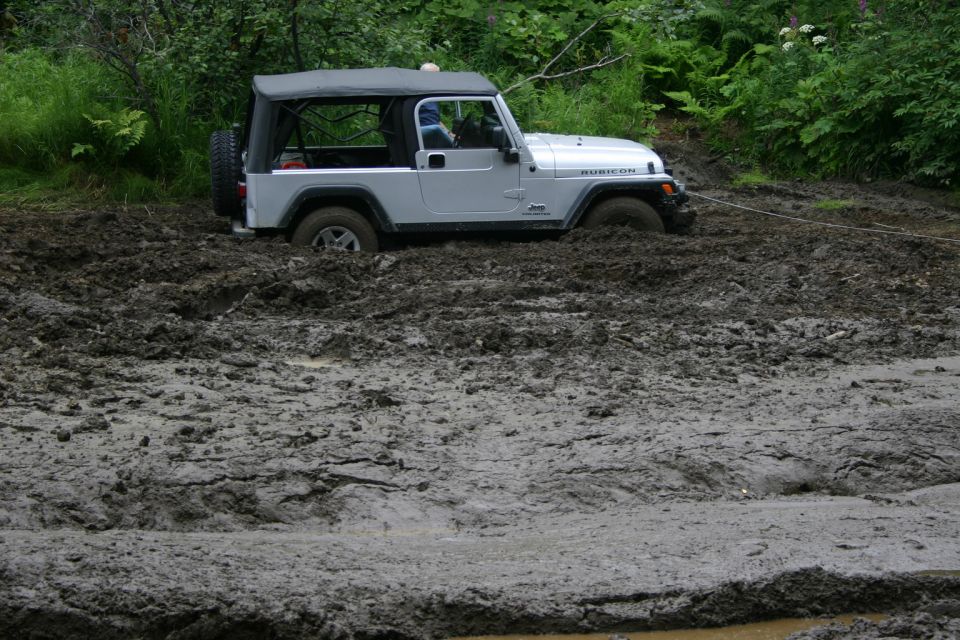 2003 Jeep TJ stuck in deep mud with a tow rope attached