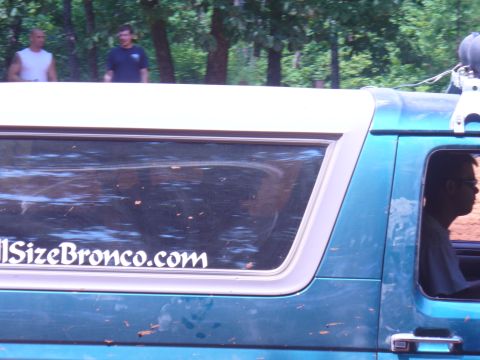1996 Ford Bronco - A teal SUV with a white roof is seen from the side, a sticker on the rear window that reads "FullSizeBronco.com".