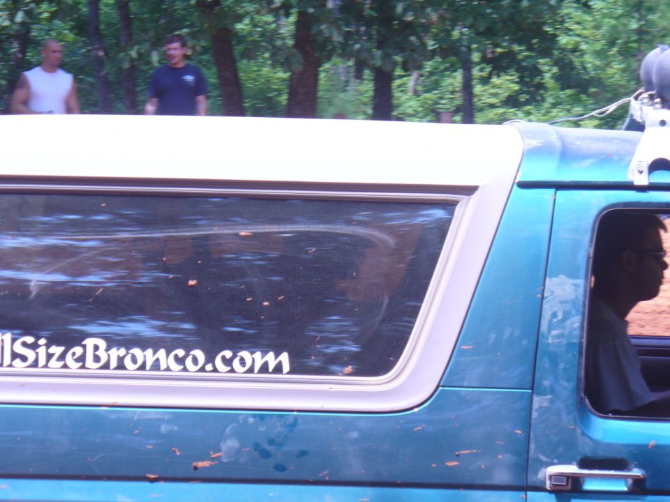 Teal SUV side view with "FullSizeBronco.com" sticker on rear window