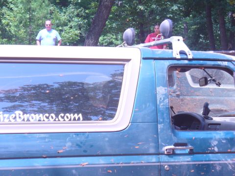 1996 Ford Bronco - A green 1996 Ford Bronco is seen from the side, with a sticker on the rear window.