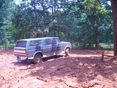1996 Ford Bronco - This extended cab Ford F-Series truck is navigating a muddy off-road course.
