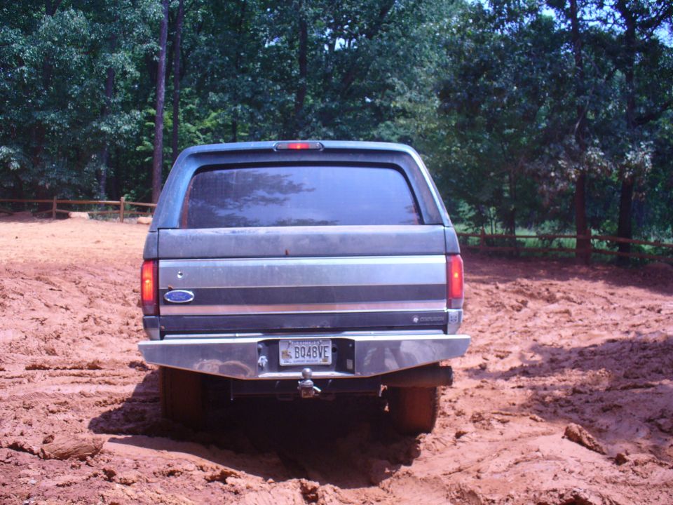 Gray Ford Bronco rear view in mud, with a chrome bumper and license plate BQ48VE