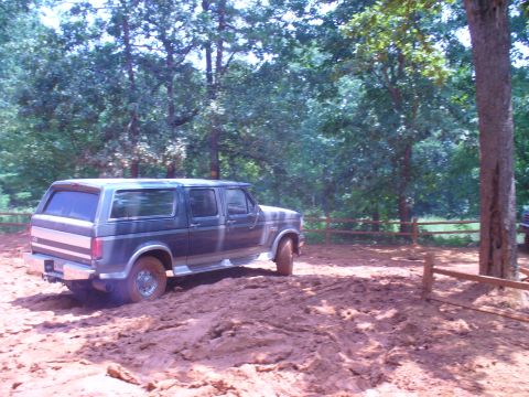 1996 Ford Bronco - Ford Bronco navigating a muddy trail during an off-road excursion.