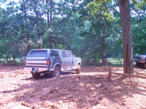 1996 Ford Bronco - This SUV navigates a muddy off-road course, appearing to be from the early 1990s.