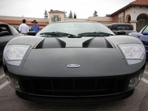 1998 Ford Crown Victoria - Head-on view of a black Ford GT showing twin hood vents, round headlights and the Ford oval badge.