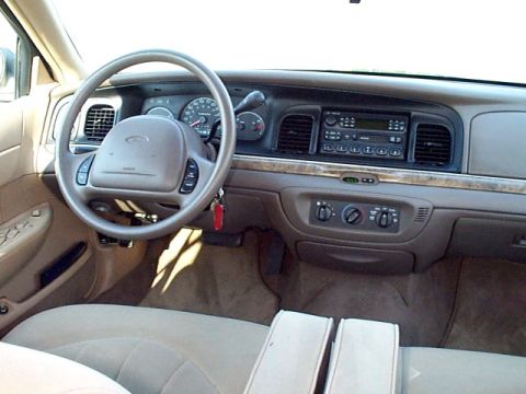 1998 Ford Crown Victoria - The interior of a 1998 Ford Crown Victoria, a tan interior and the driver's side controls.