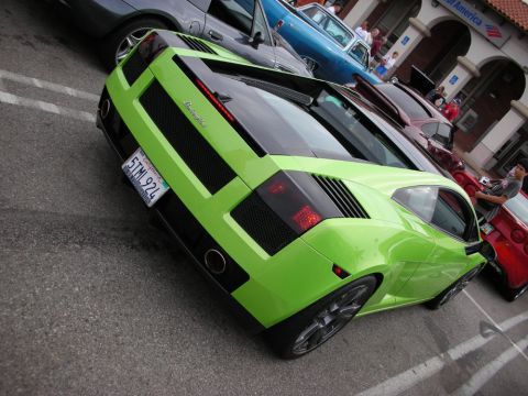 1998 Ford Crown Victoria - lime-green Lamborghini Gallardo seen from the rear quarter, its engine louvers and tail lights prominent among other show cars.