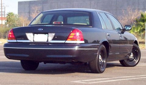1998 Ford Crown Victoria - Rear view of a dark 1998 Ford Crown Victoria sedan.
