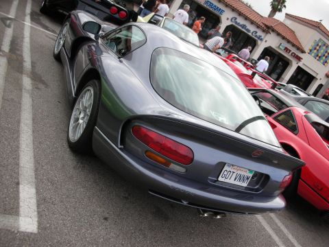 1998 Ford Crown Victoria - rear of a gray Dodge Viper coupe shows round taillights and a California GOT VNM plate, parked beside a red car at a meet.