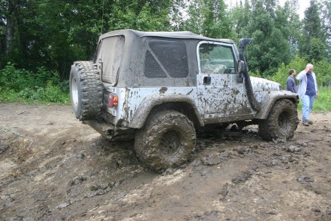 2003 Jeep TJ - This Jeep Wrangler is covered in mud after navigating a difficult off-road trail.